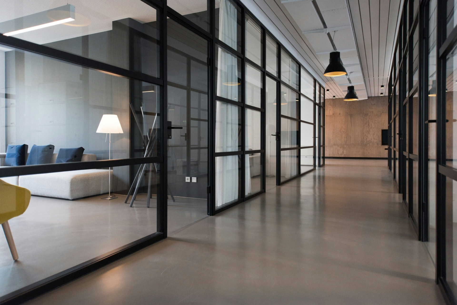 Empty modern office space with glass walls and polished floors